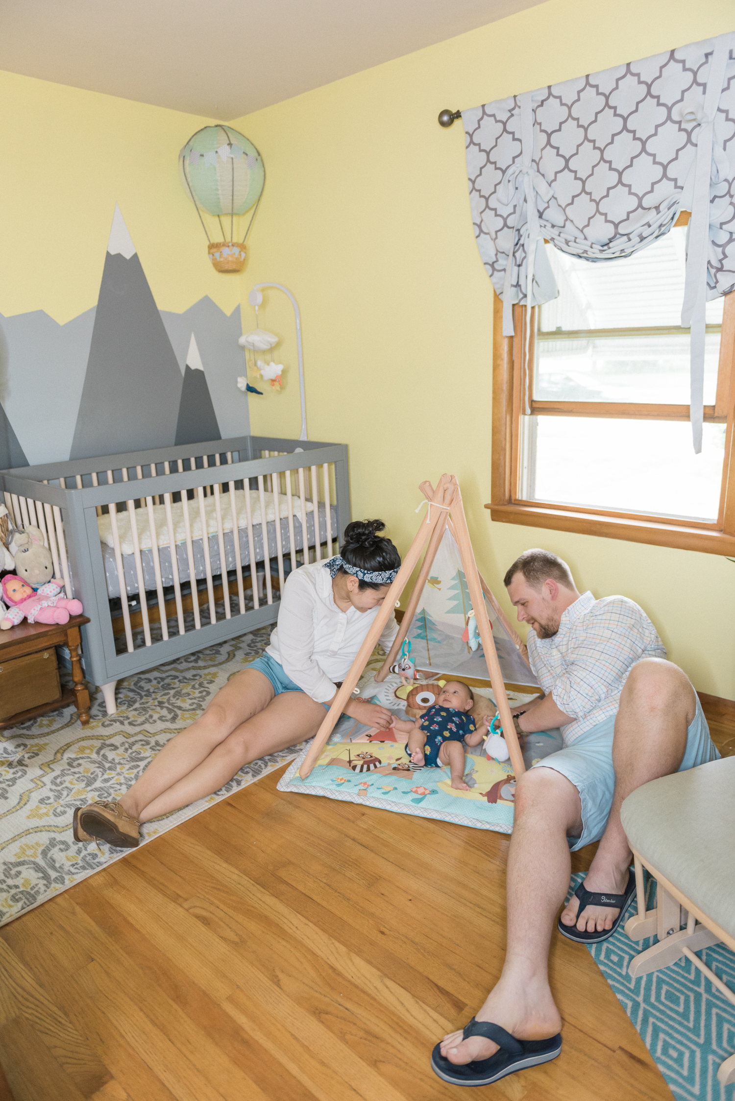 Family Lifestyle session with a newborn at their yellow nursery room