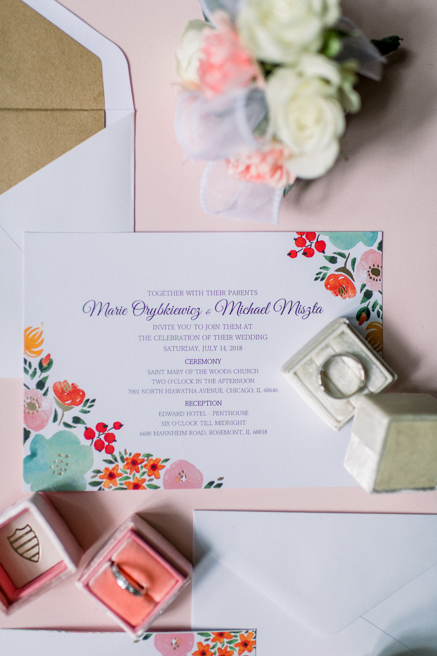Pink and white wedding invitations with the wedding ring on top