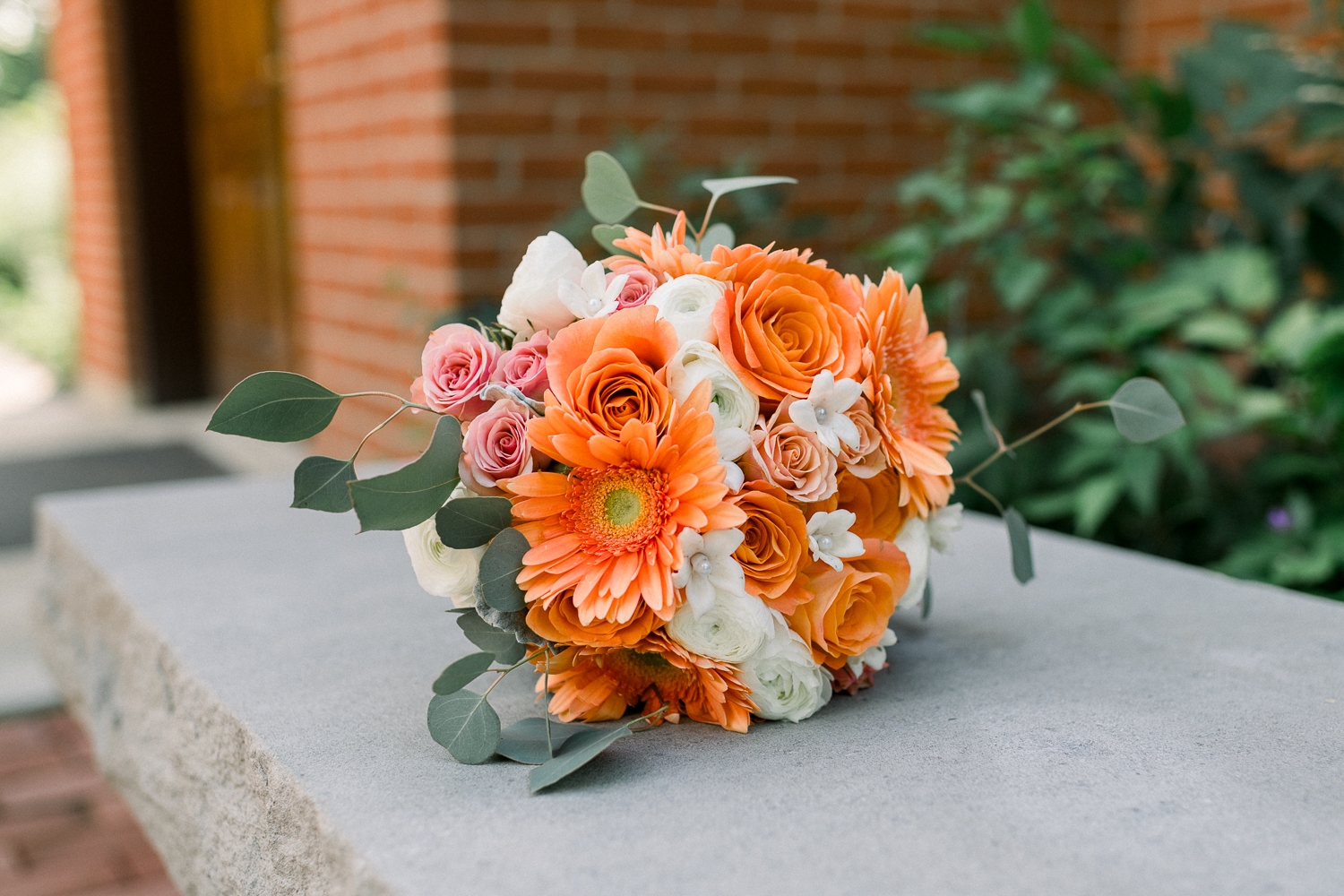 Orang and white floral arrangement for the bridal bouquet