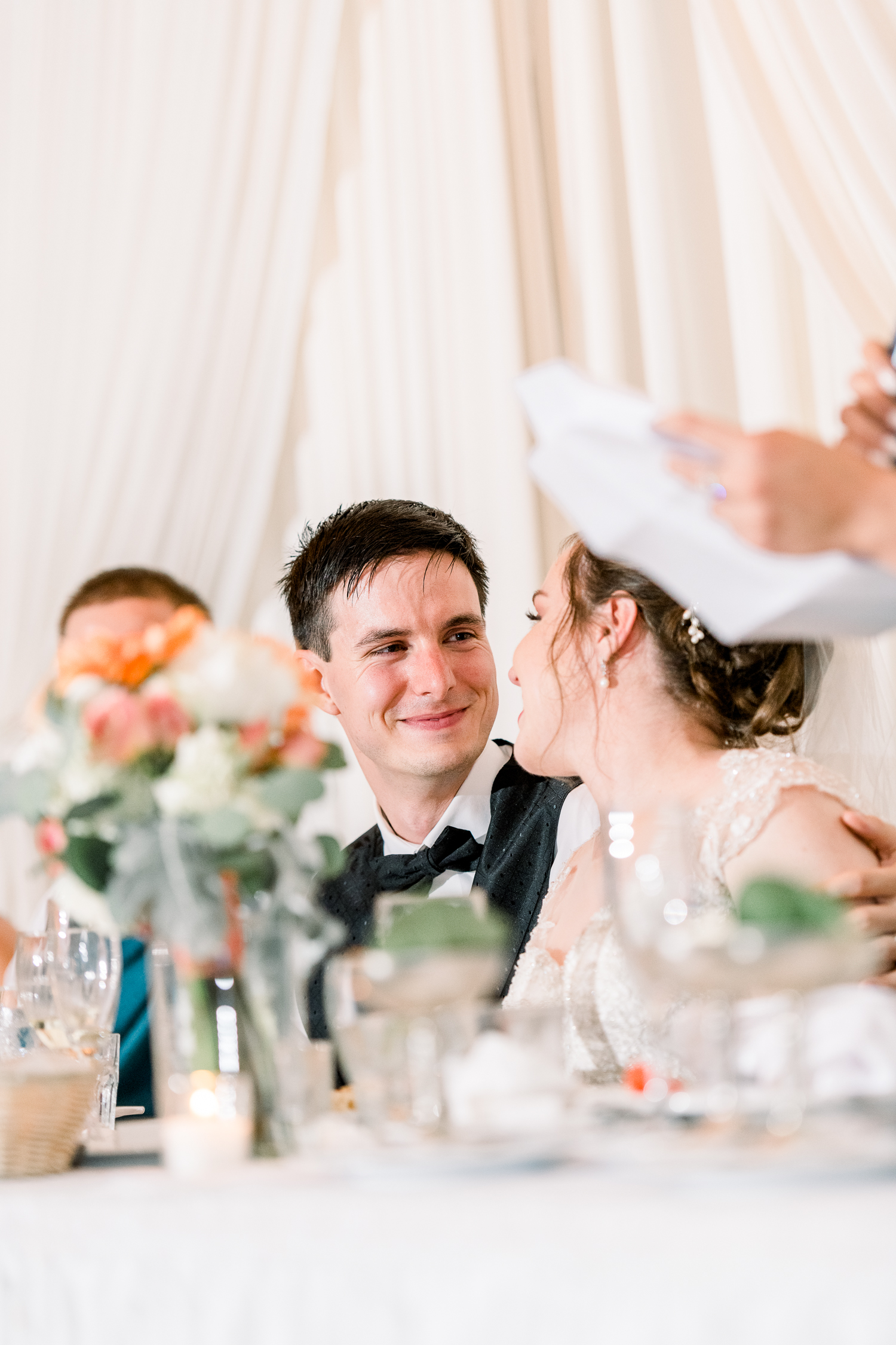 Groom looks at bride with a smile