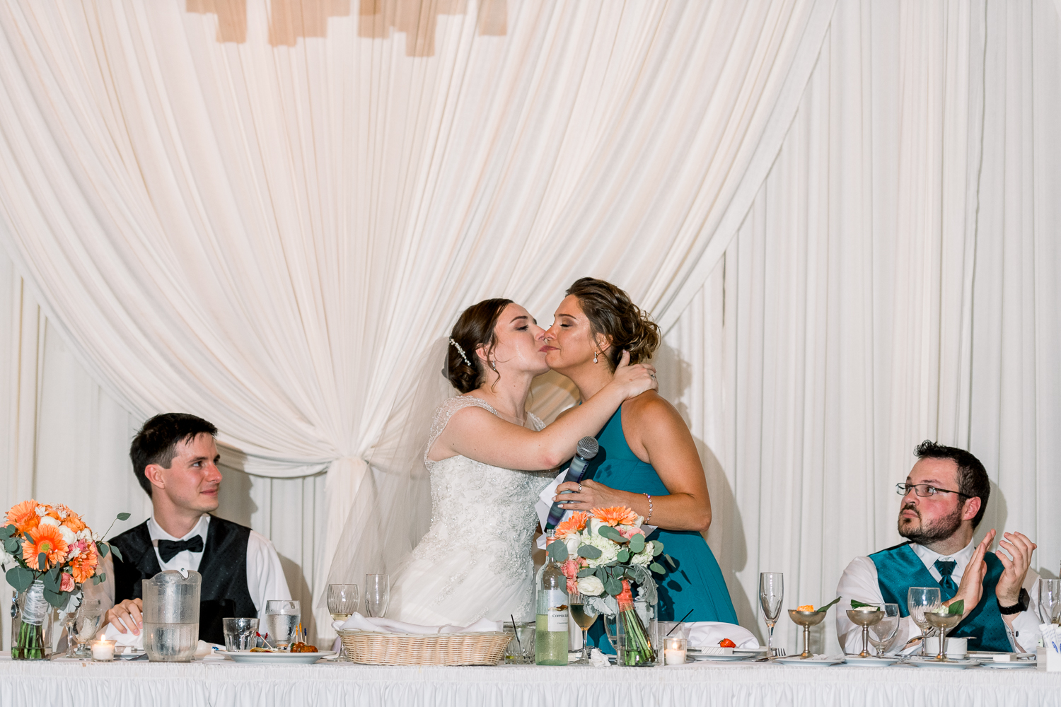 Bride kisses maid of honor in the cheek after her speech