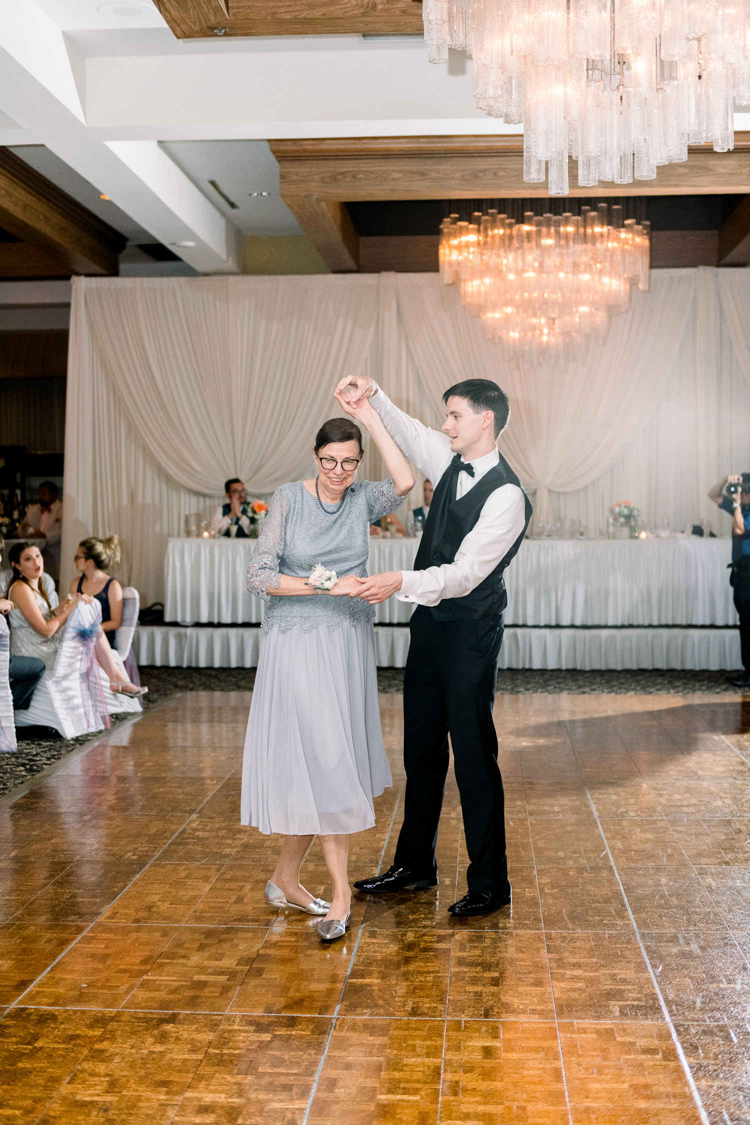 Groom twirls mother on their first dance