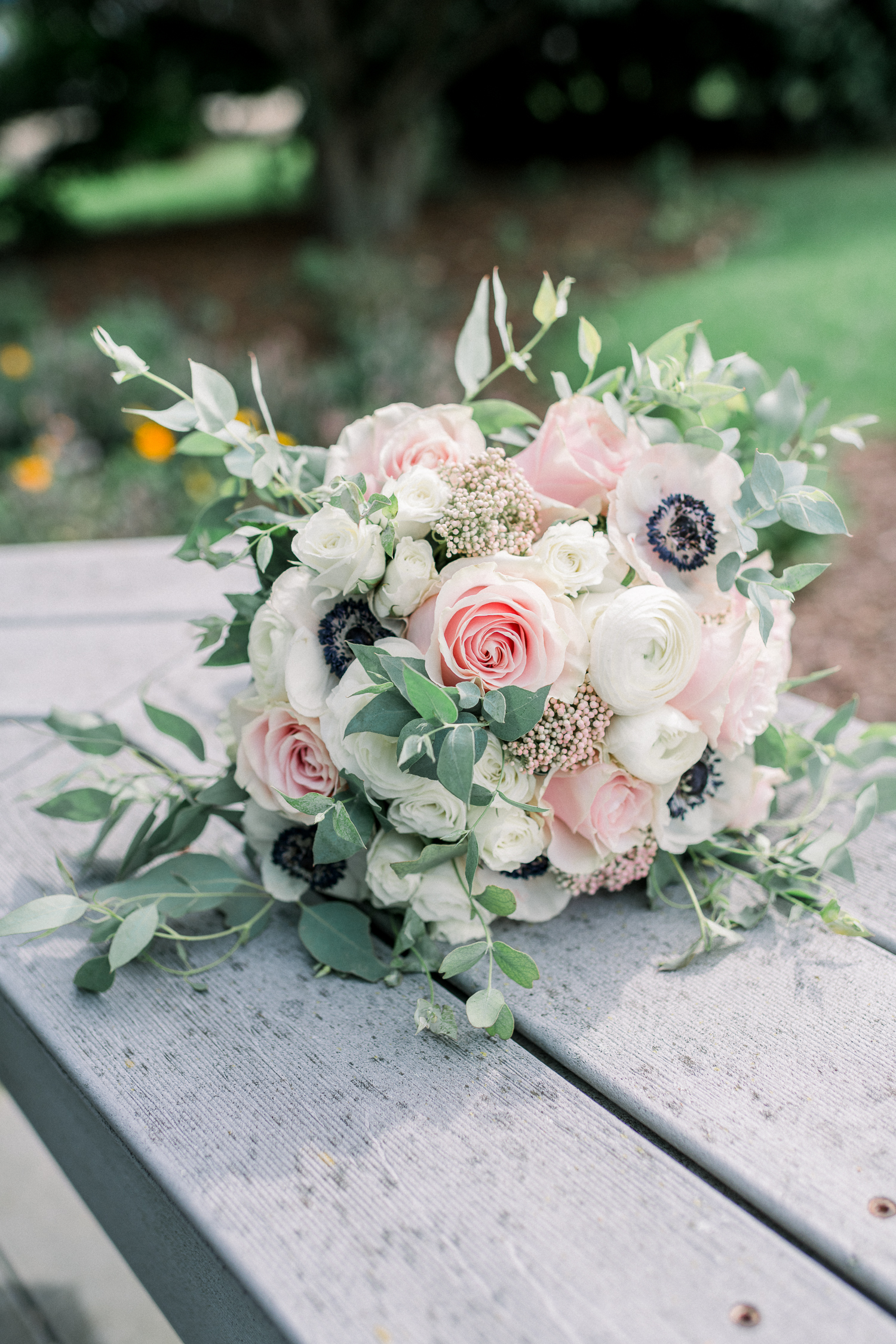 Bridal bouquet with blush pink and white roses and greenery