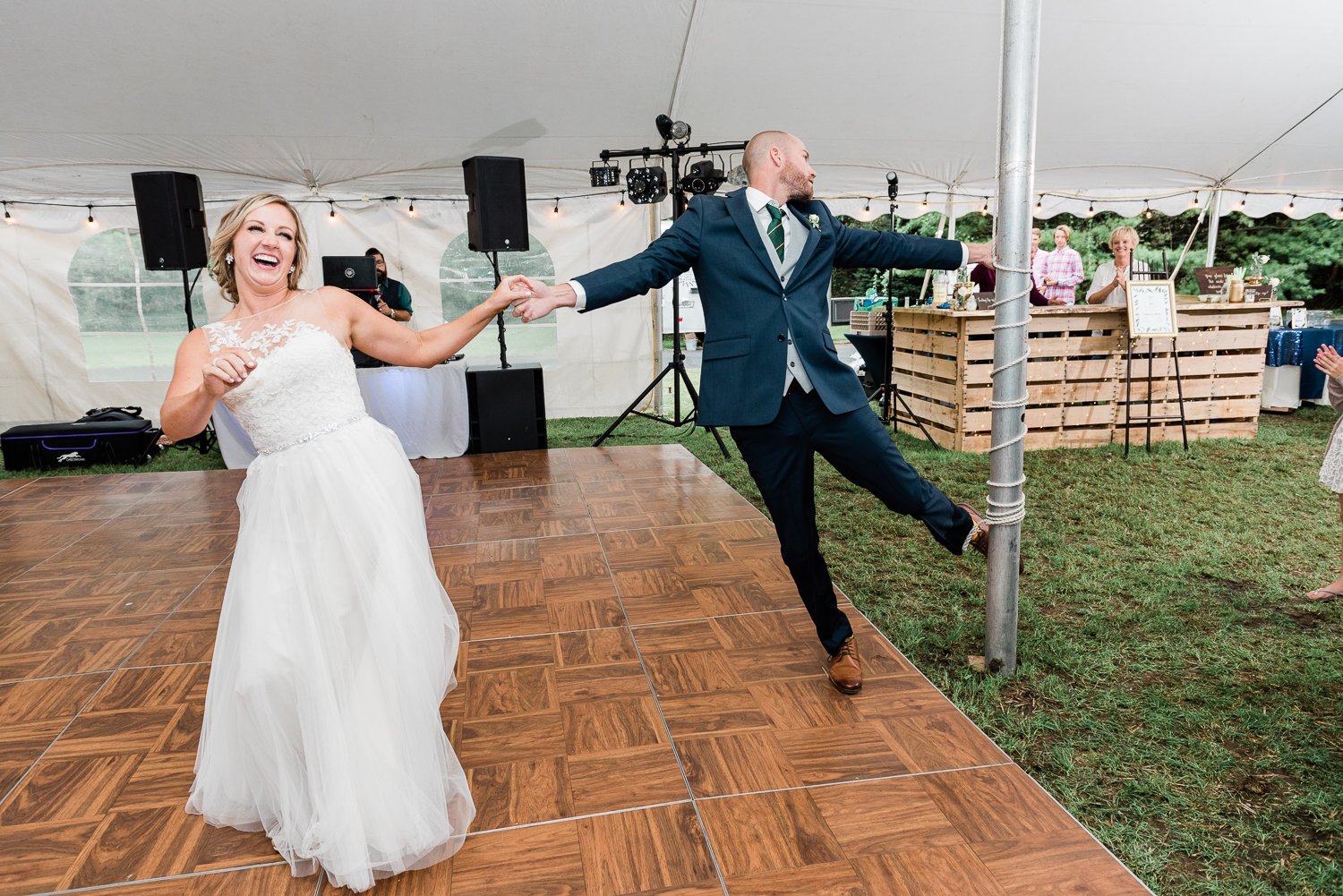 Newly married couple dancing at backyard tent wedding