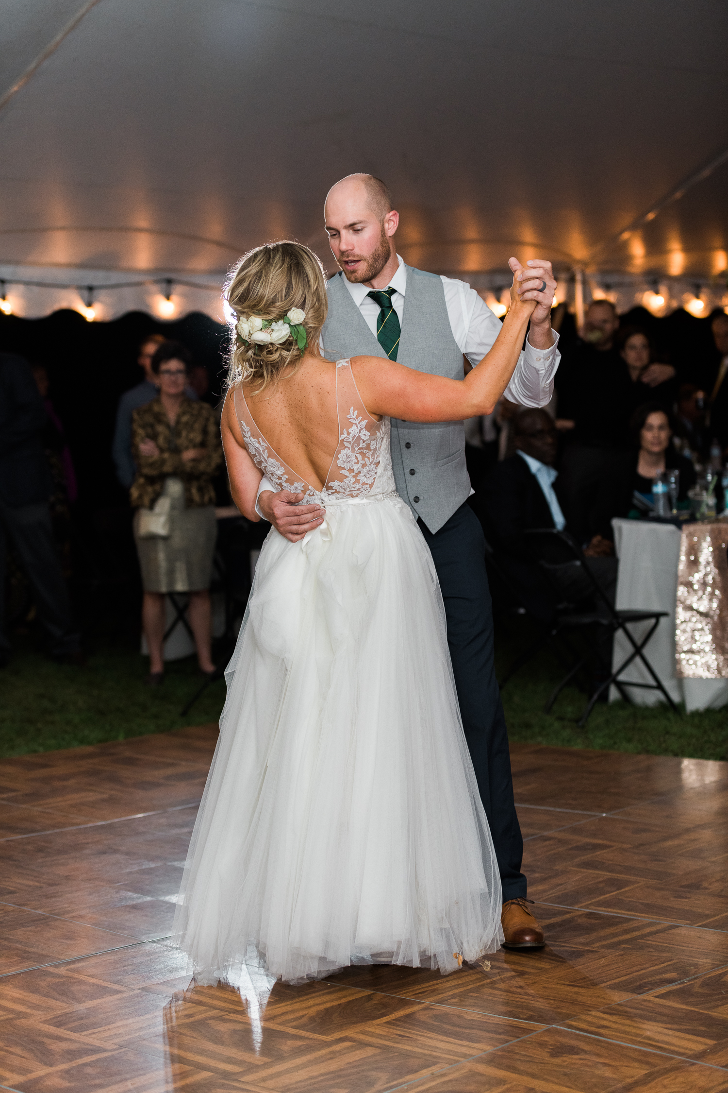 Newly married couple dancing at backyard tent wedding