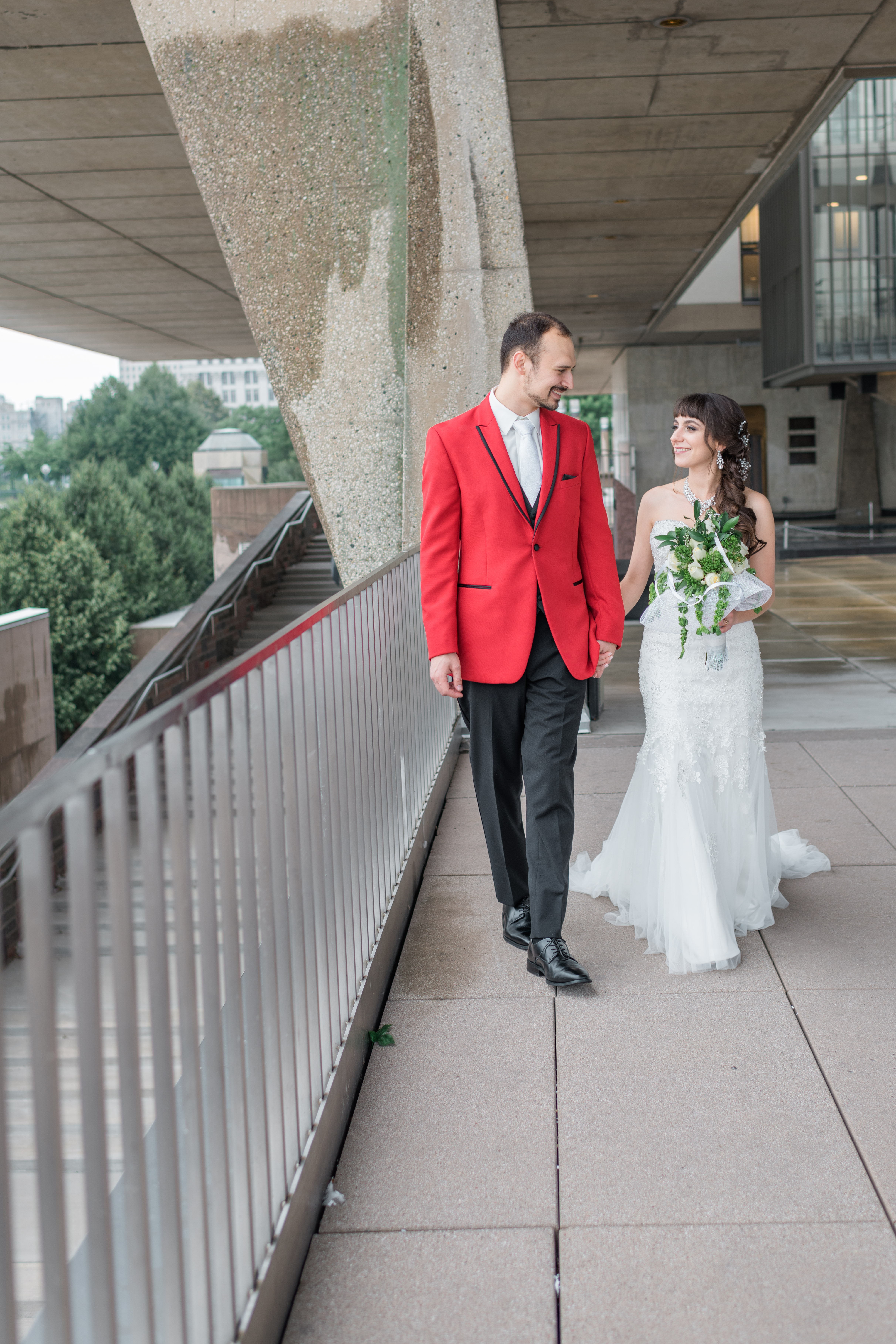Bride and groom walking along War Memorial Museum in Milwaukee
