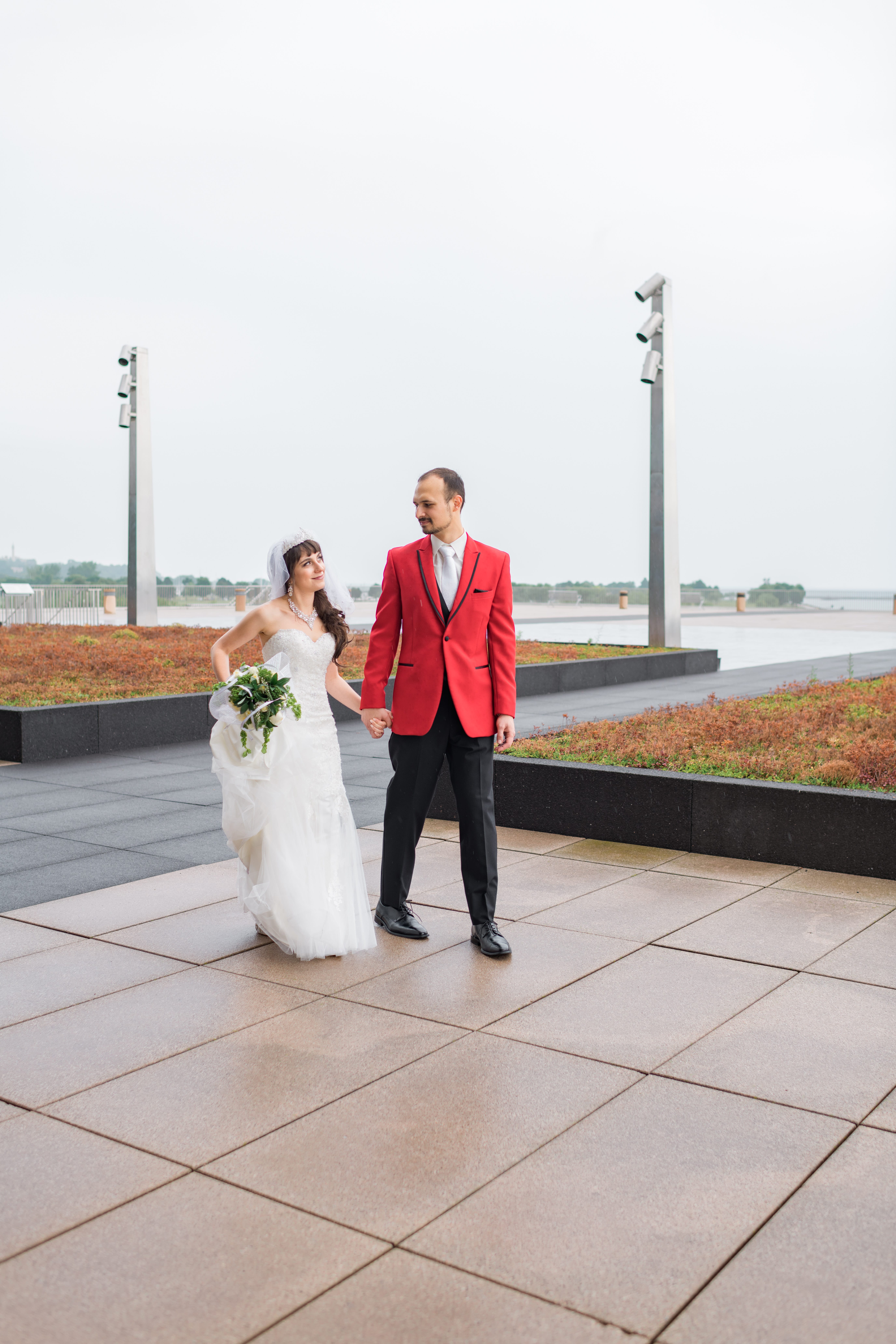 Bride and groom walking along War Memorial Museum in Milwaukee
