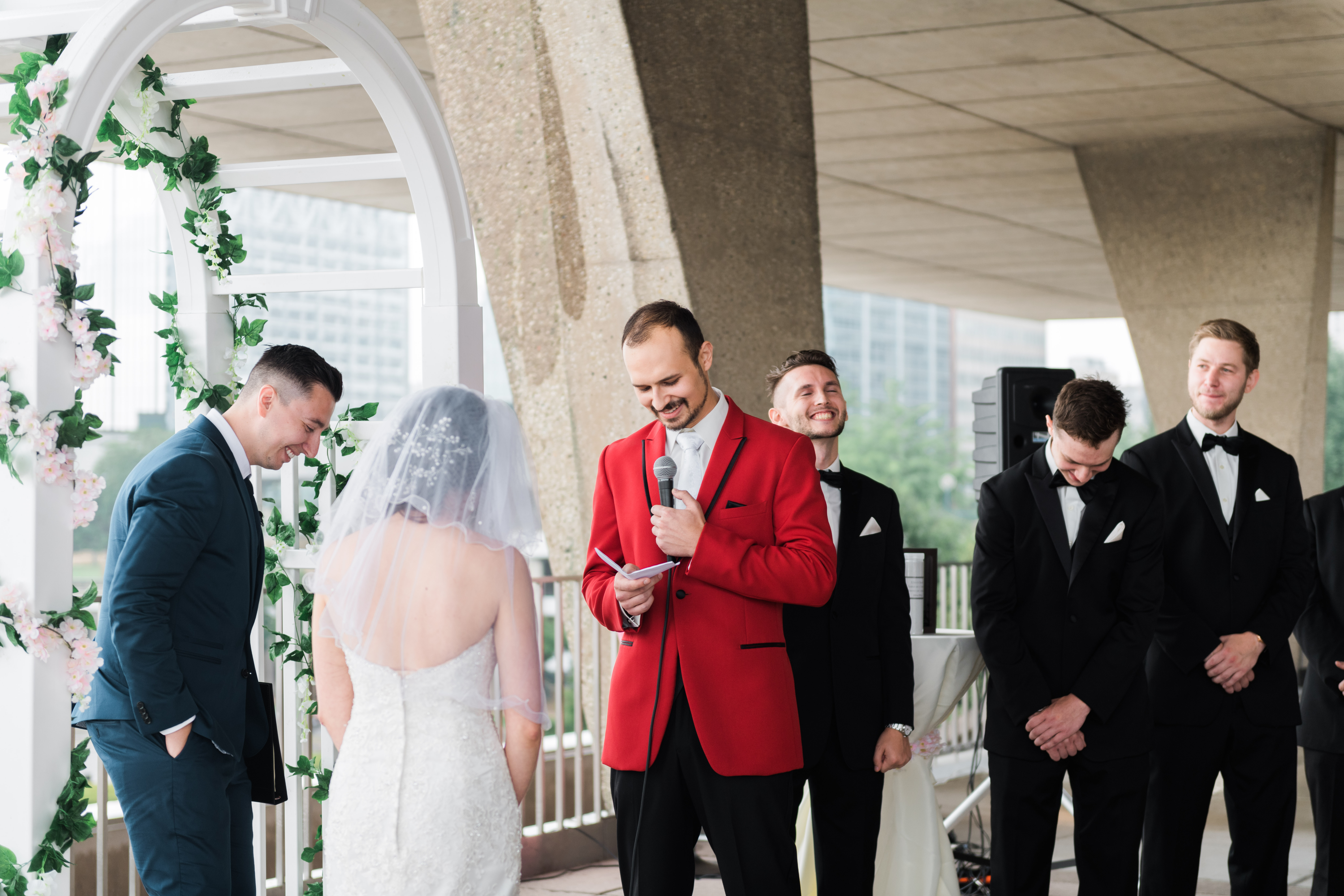 Groom smiles as he reads his vows