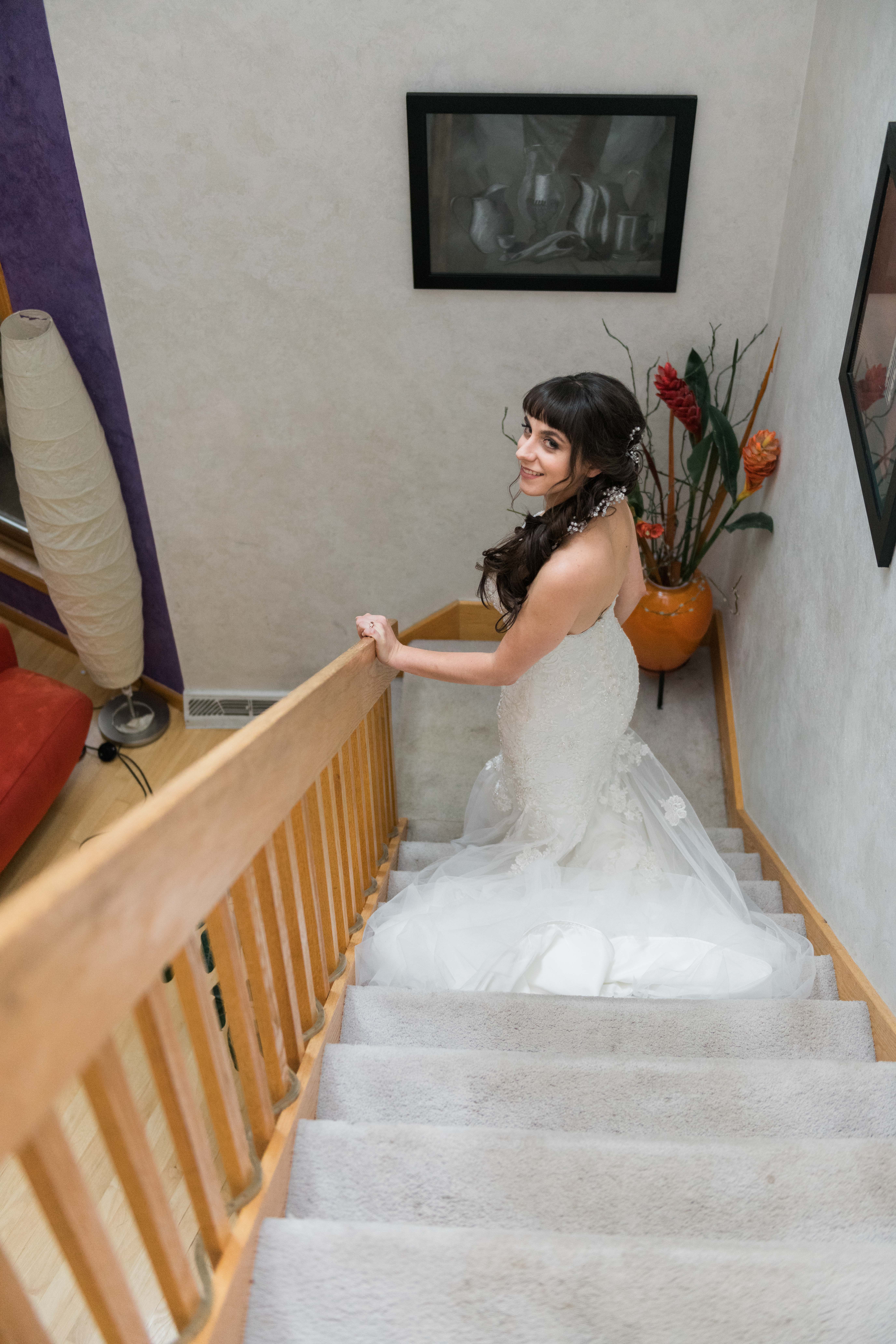 Bride looking back to the camera going down the stairs in her dress