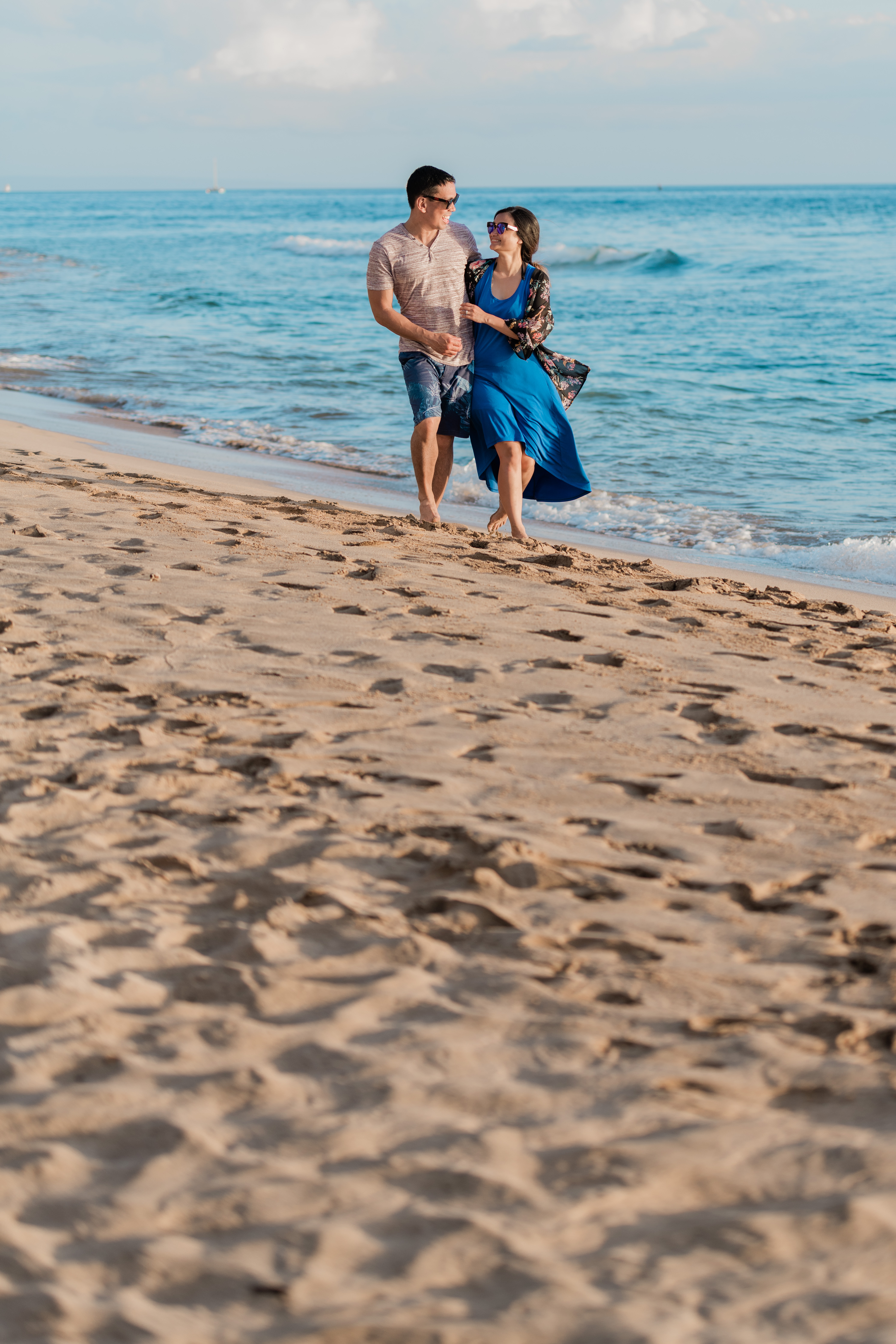 romantic couple walking along the beach during a Maui Engagement Session