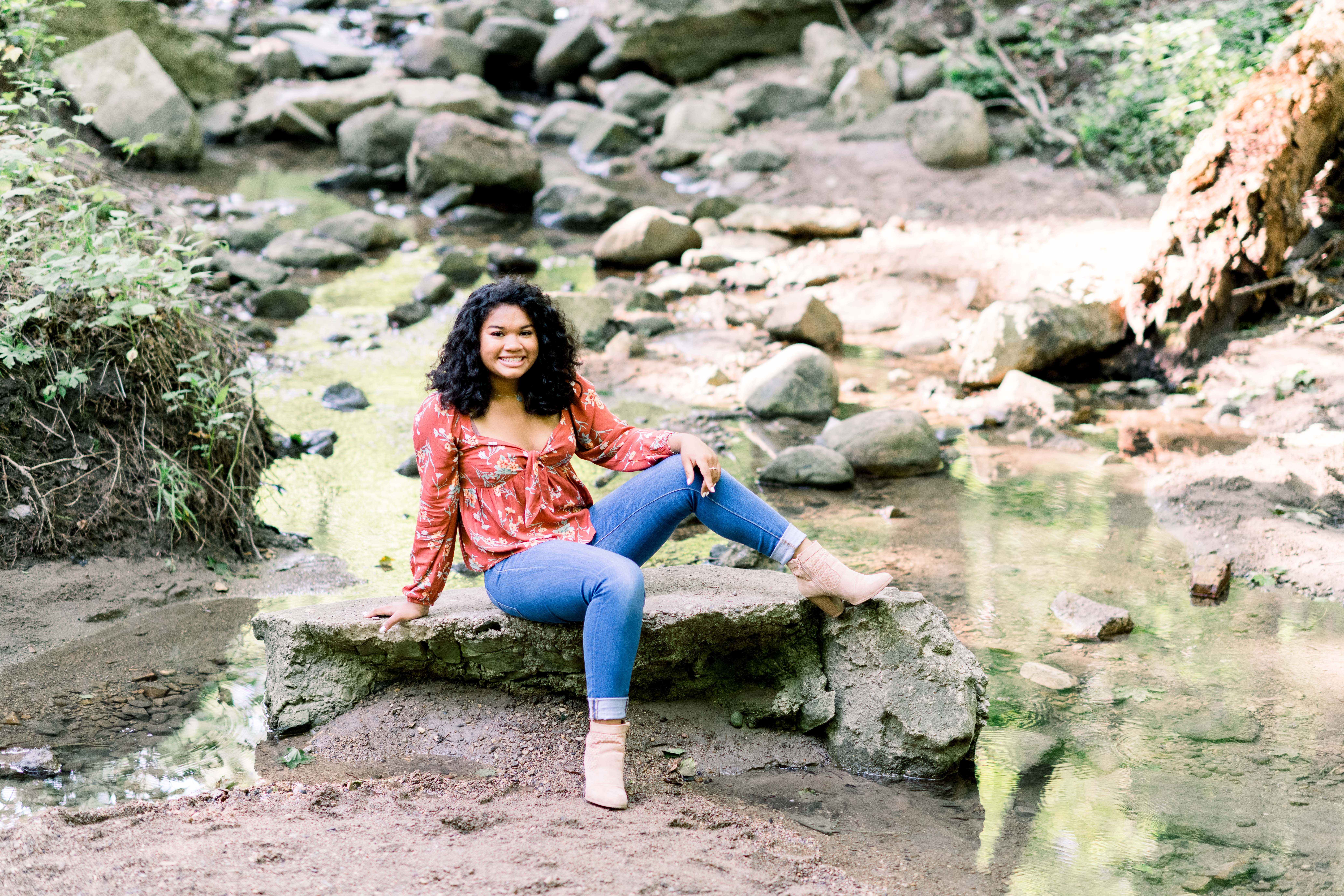 Posing on a rock during a senior portrait session