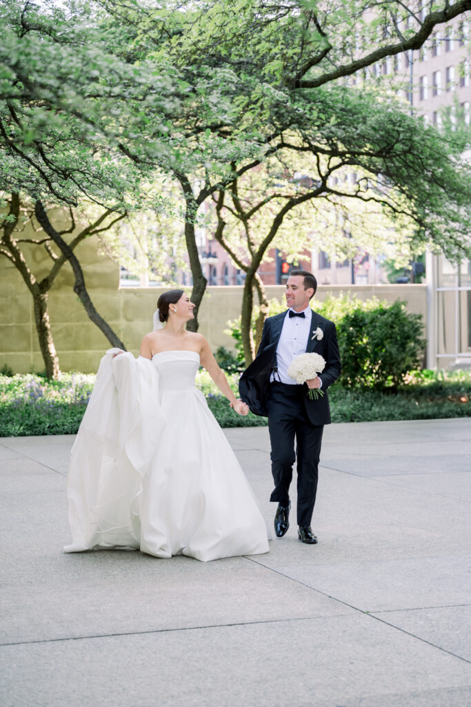 Couple in wedding attire at South Garden at the Art Institute of Chicago with trees behind them