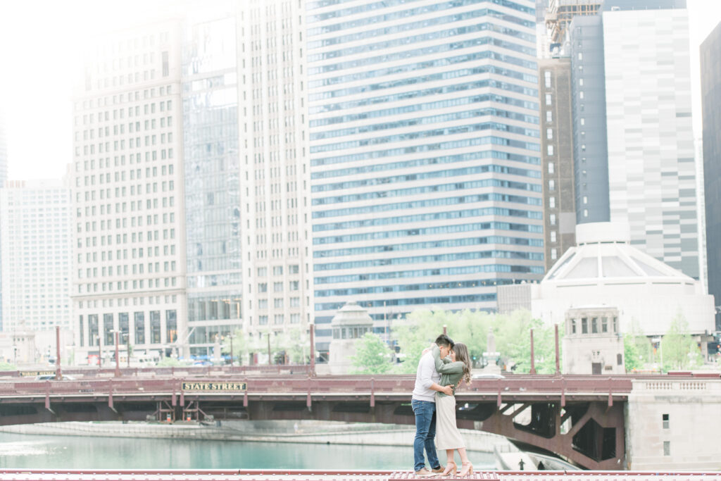 Couple on top of the bridge with the Chicago Skyline in the background