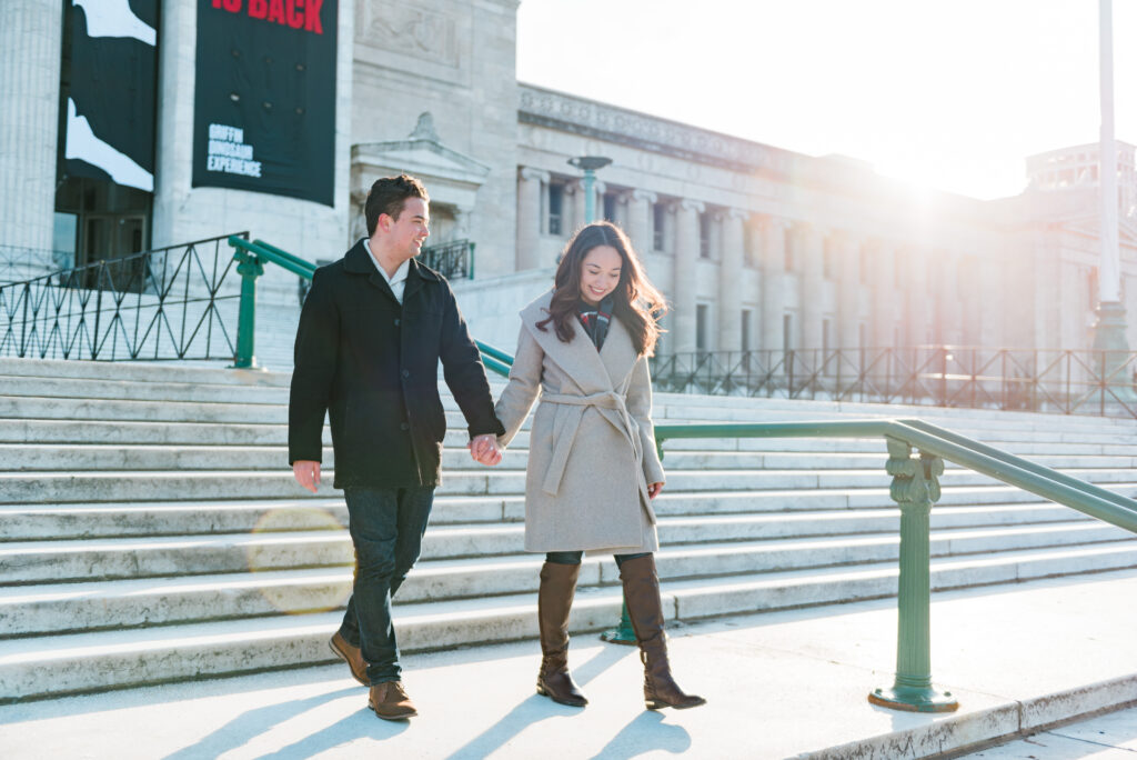 Couple walking down the steps of Field Museum Chicago building on Museum Campus