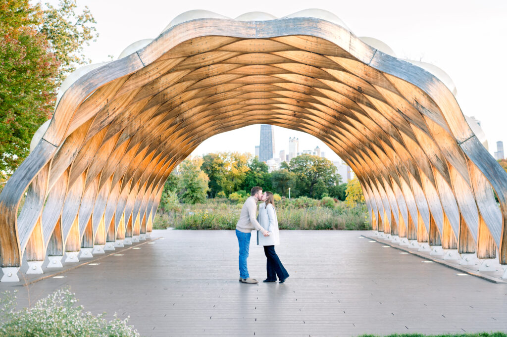 Couple kissing under the Honeycomb structure at Lincoln Park Chicago 
