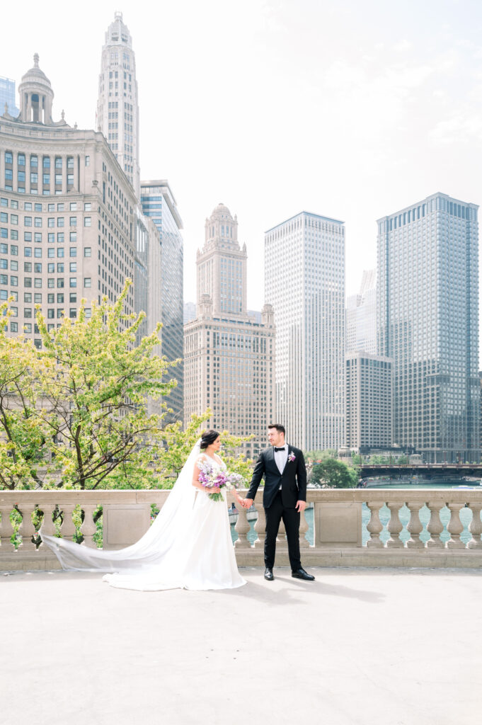 Newlywed walking by Riverwalk by the Wrigley Building